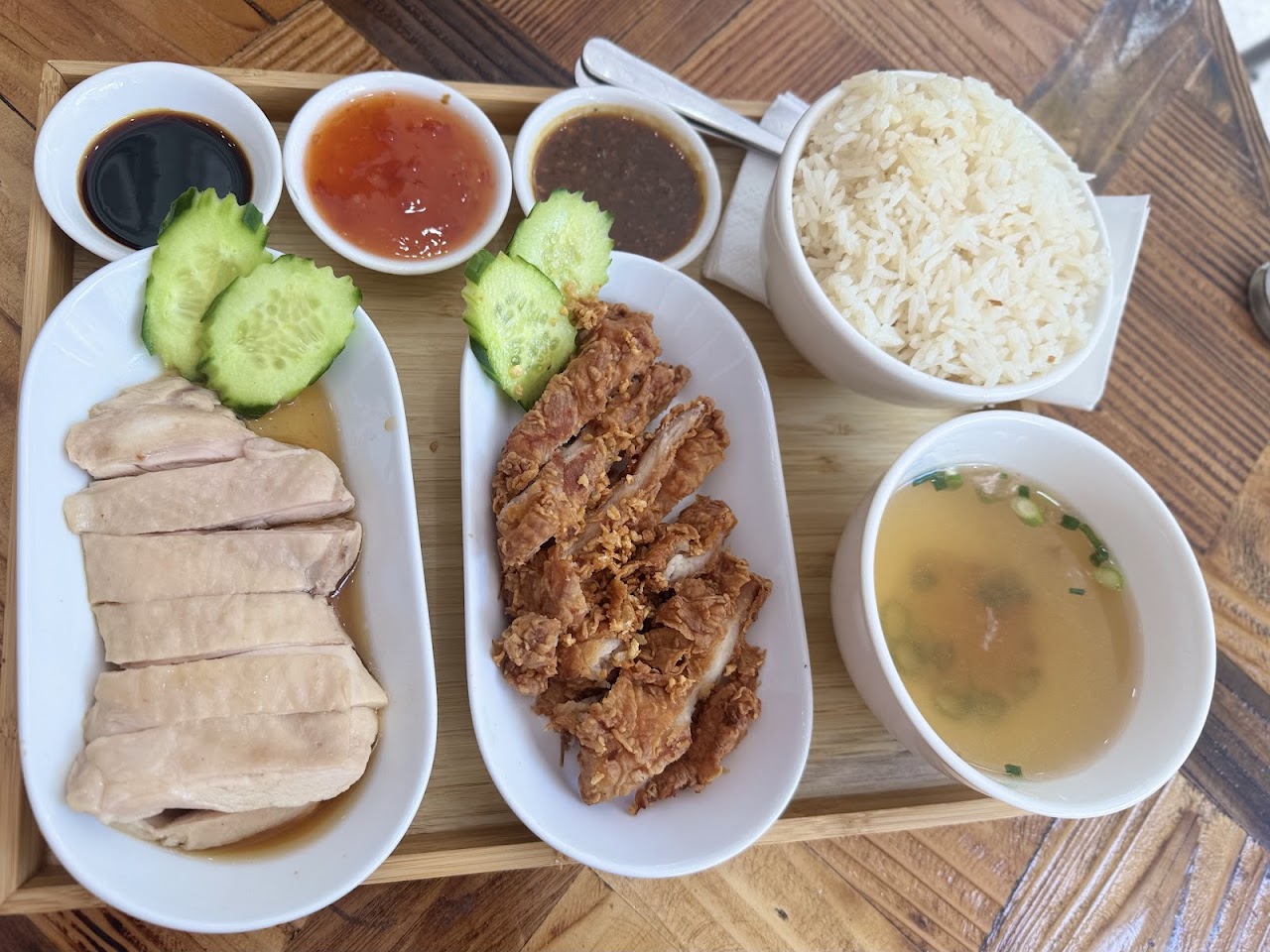 Chicken and pork plate with rice, broth, and sauces